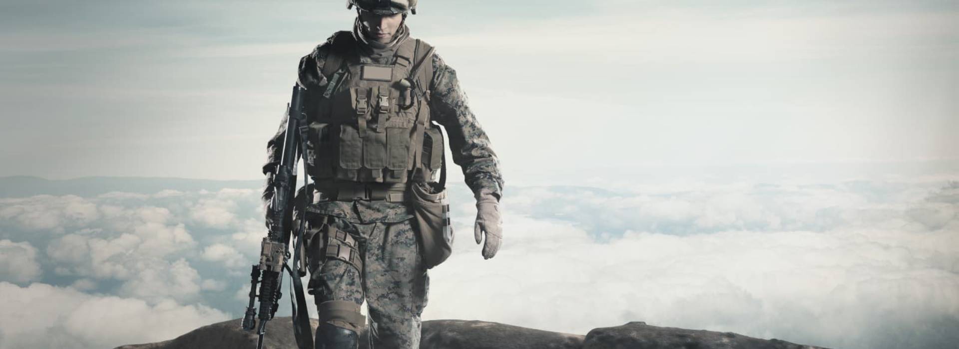 A soldier in camouflage tactical gear and a police officer in a navy duty uniform standing side by side